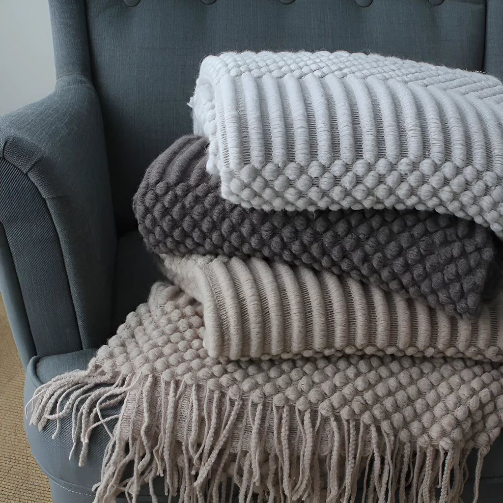 Small light grey polyester throw blanket folded, showing its rectangular 127cm by 170cm size.