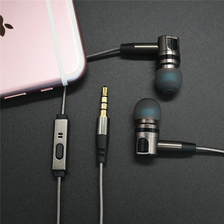 Titanium grey metal in-ear earphones with a detachable cable on a grey background.