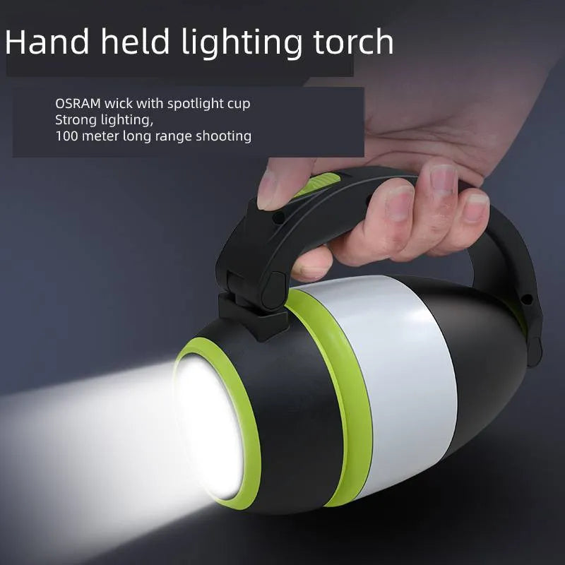 Black green multifunctional LED camping lamp with USB port shown next to a mobile phone.