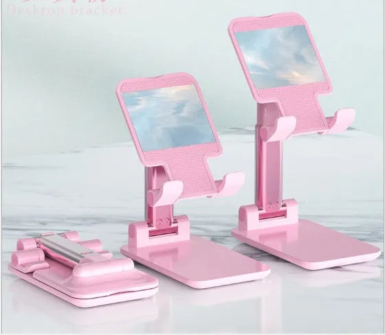 Black silicone and ABS plastic desk mobile phone holder on a wooden table.