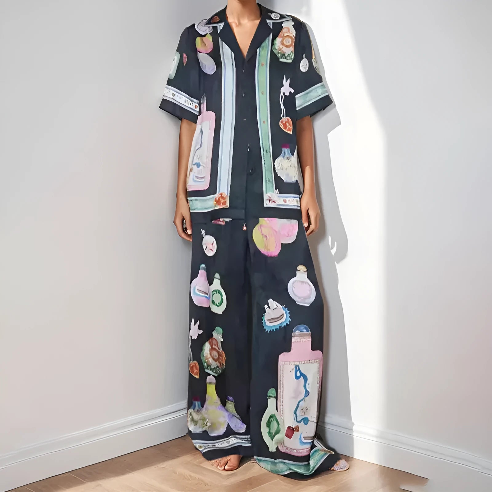Black women's cardigan and trousers set with cartoon animation print, shown as a two-piece outfit.
