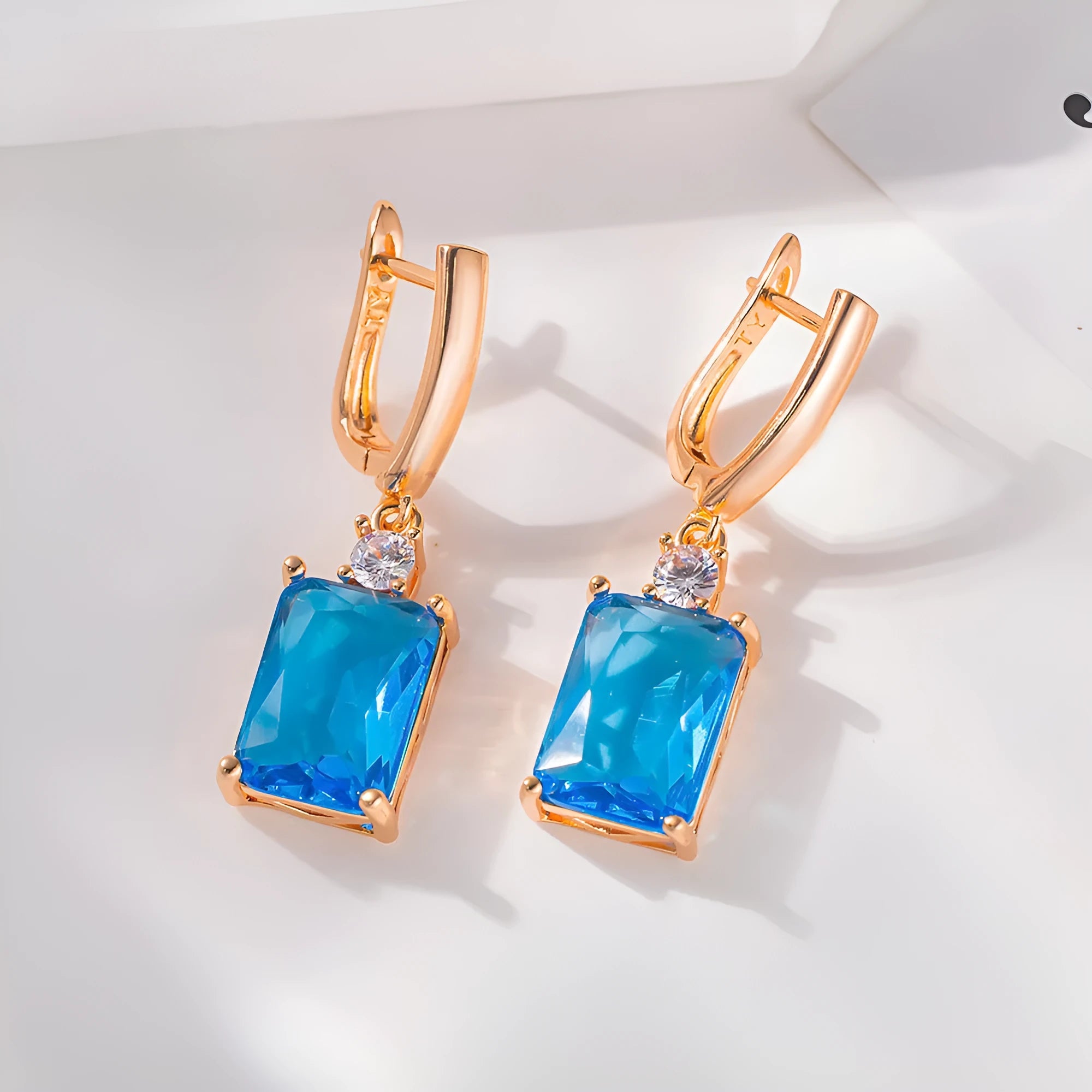 Square copper earrings with electroplated gold or silver finish and quadrilateral geometry