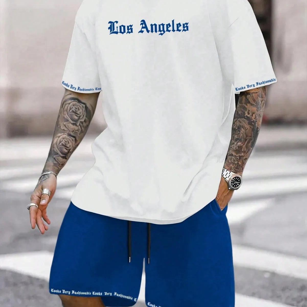 Men's blue short-sleeved sports top and matching shorts suit set on a hanger