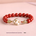 Cinnabar bracelet with Hetian Jade lotus charm and Bells of Ireland accents in New Chinese style