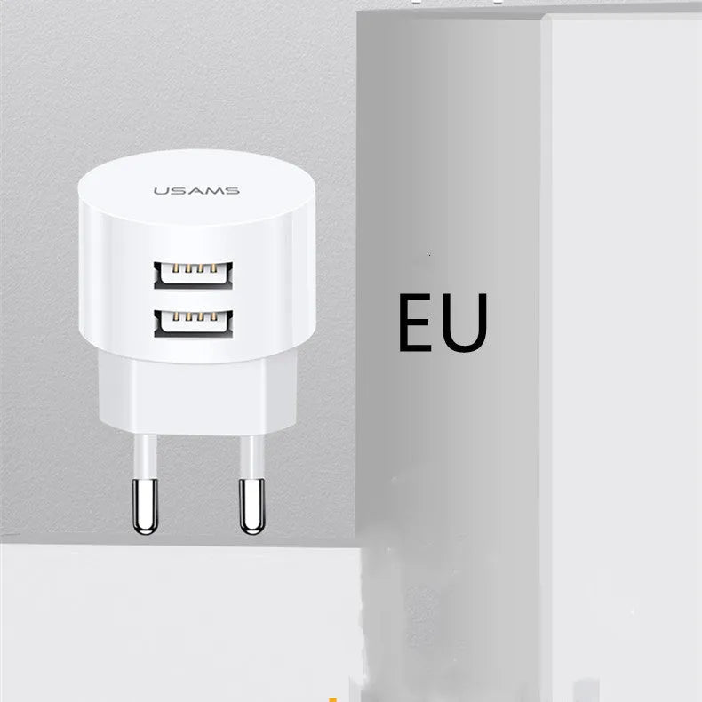 White portable universal dual USB phone charger showing US, EU and UK plug compatibility