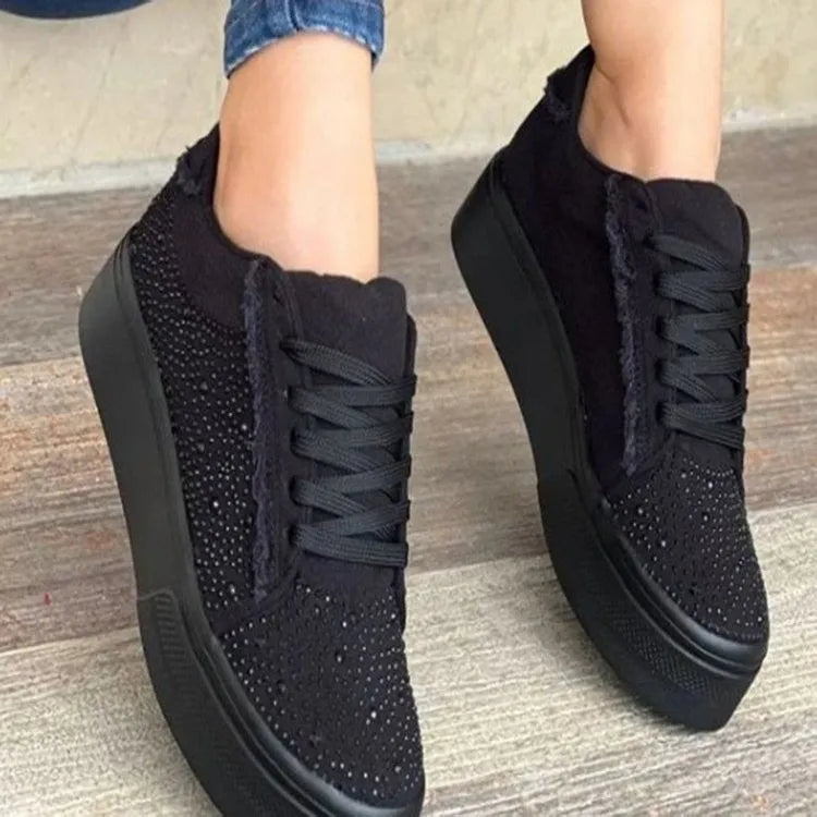 Women's black casual sports shoes with lace-up front, rhinestone detail, and thick rubber sole.