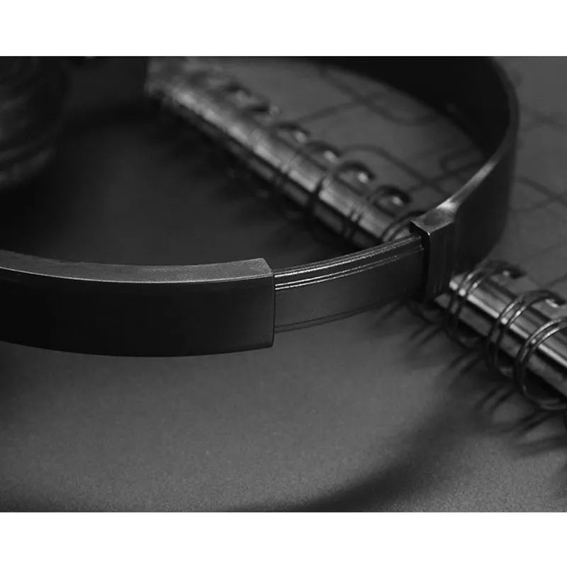 Black folding wired over-ear headphones with adjustable headband and 3.5mm plug.
