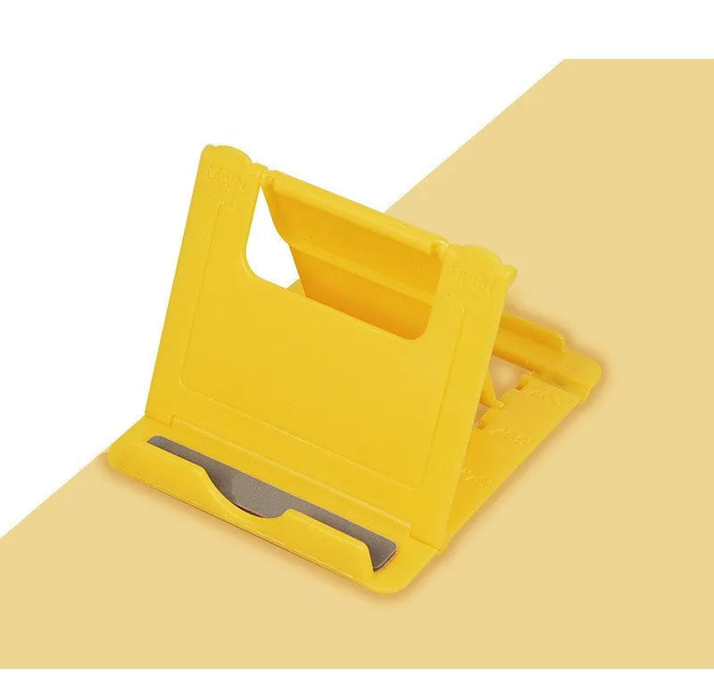 Multifunctional folding ABS stand for mobile phones and tablets, shown folded and in black colour