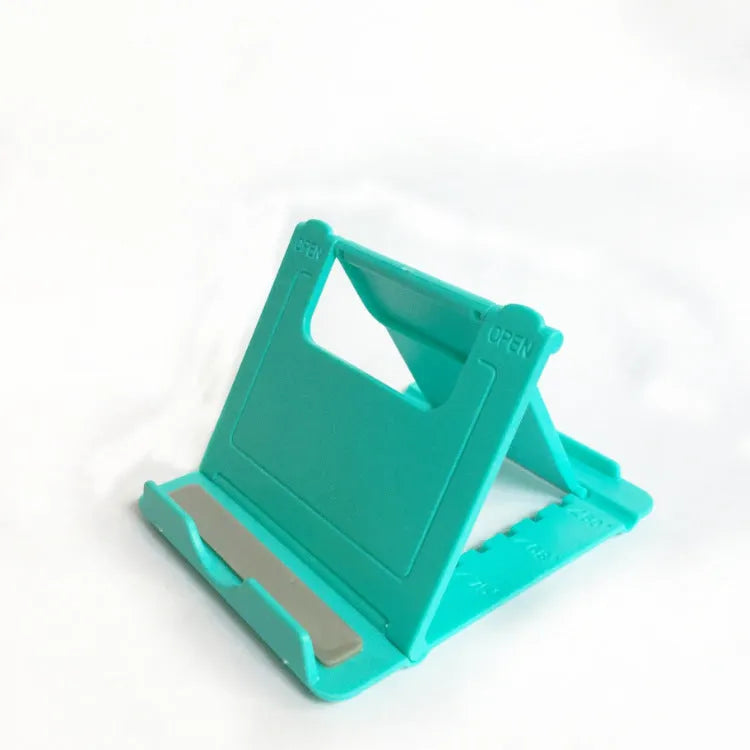 Multifunctional folding ABS stand for mobile phones and tablets, shown folded and in black colour