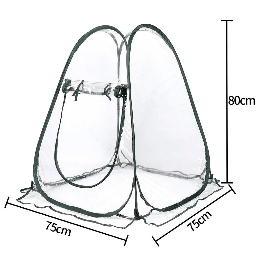 Transparent PVC conservatory tent 90 cm outer size protecting garden plants from frost, with ground nails visible
