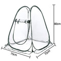 Transparent PVC conservatory tent 90 cm outer size protecting garden plants from frost, with ground nails visible