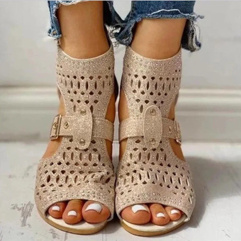 Women's beige flat sandals with a back zipper, fish mouth toe, and low wedge heel.