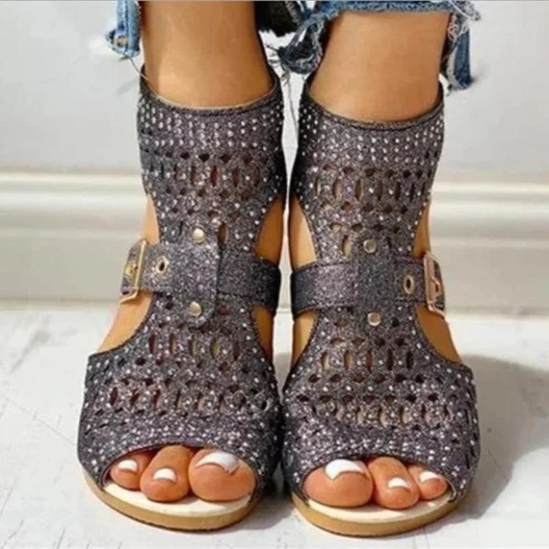 Women's beige flat sandals with a back zipper, fish mouth toe, and low wedge heel.