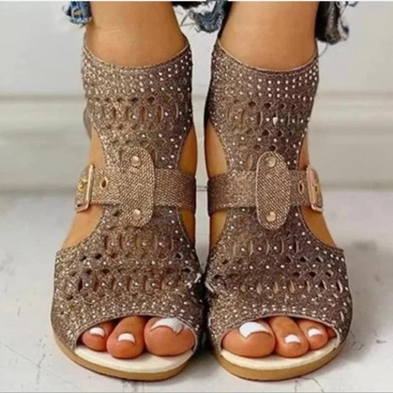 Women's beige flat sandals with a back zipper, fish mouth toe, and low wedge heel.