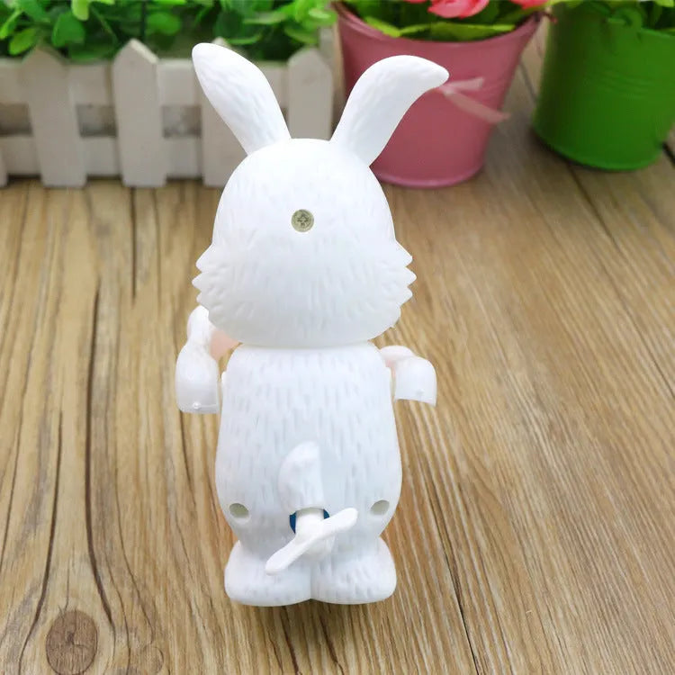 Cartton white plastic rabbit drumming clockwork wind-up toy measuring 6x13cm