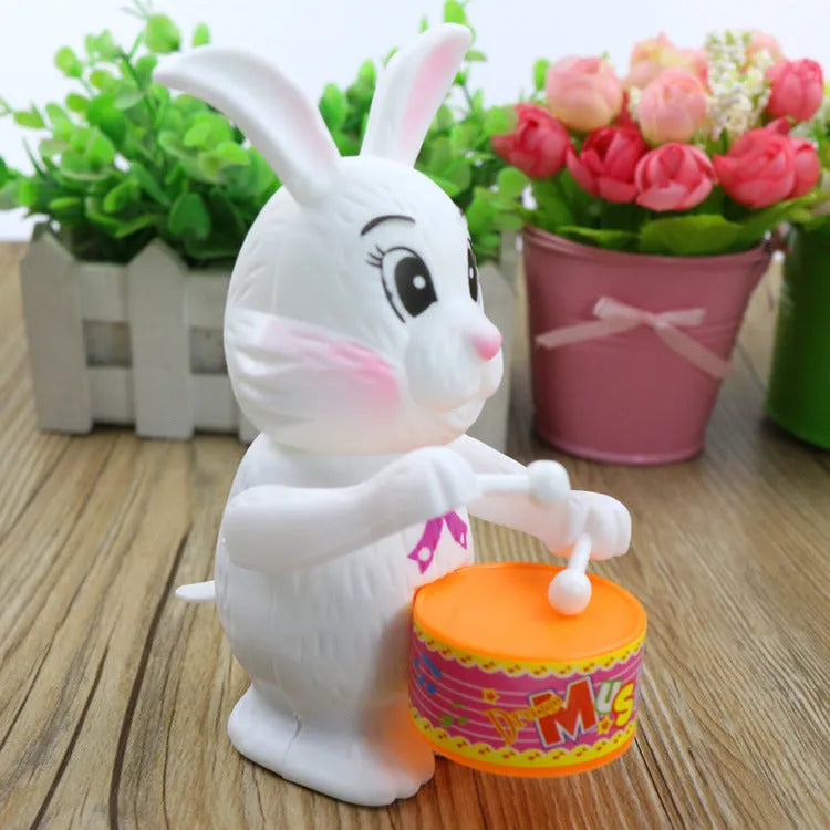 Cartton white plastic rabbit drumming clockwork wind-up toy measuring 6x13cm