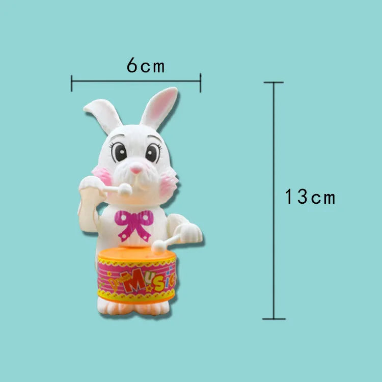 Cartton white plastic rabbit drumming clockwork wind-up toy measuring 6x13cm