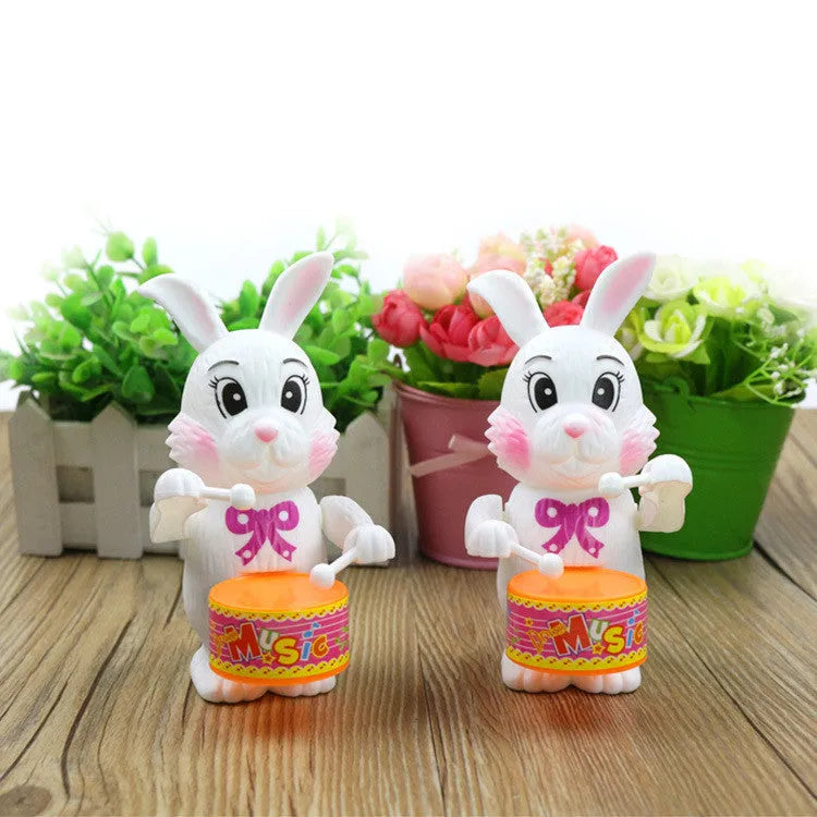 Cartton white plastic rabbit drumming clockwork wind-up toy measuring 6x13cm