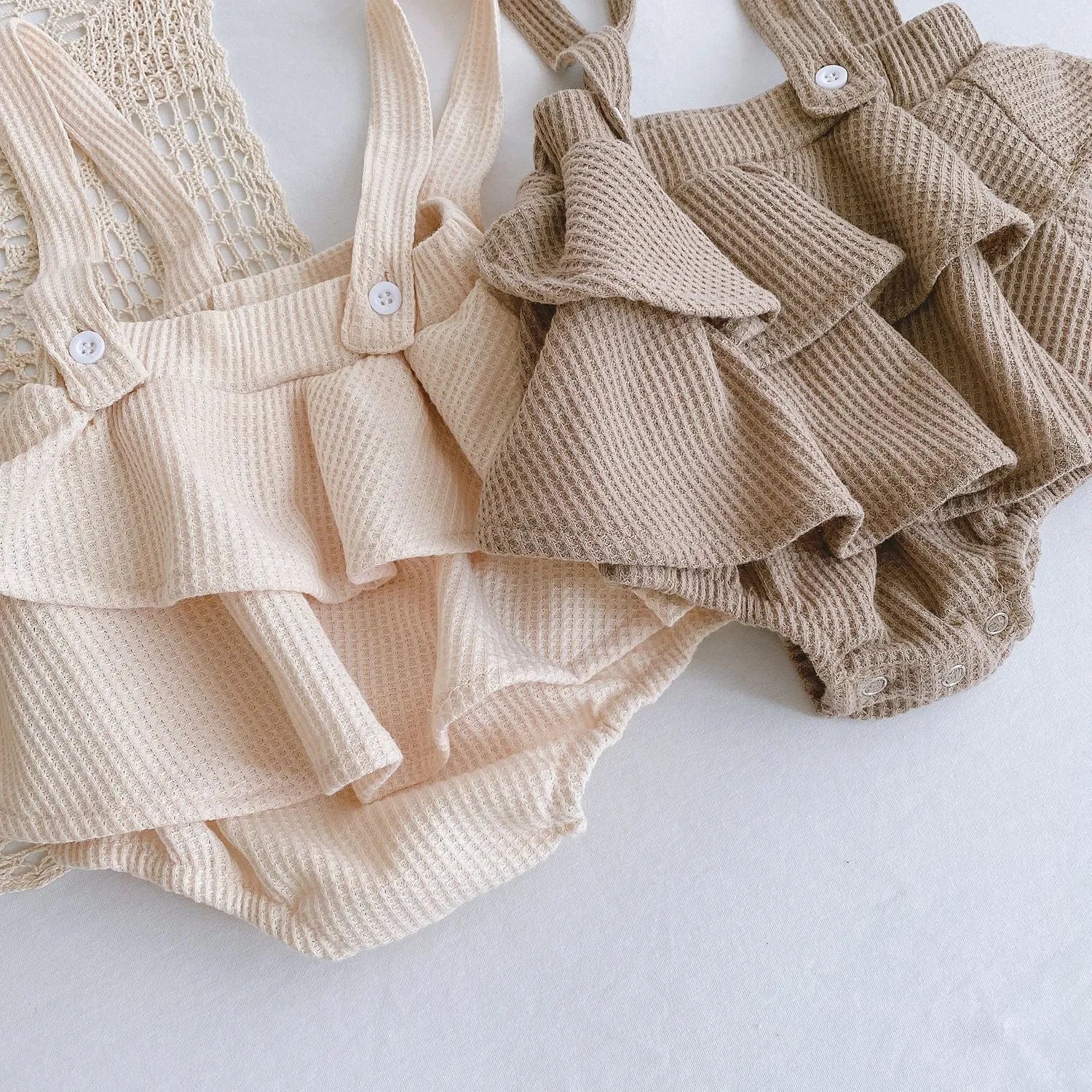 Baby girl romper with pleated lotus leaf design in cotton fabric, showing triangle climb style