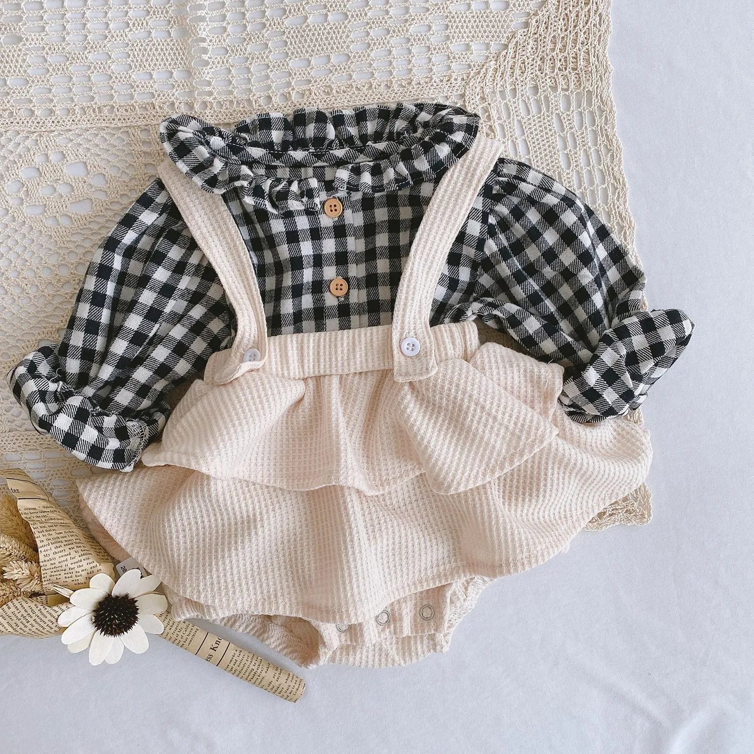 Baby girl romper with pleated lotus leaf design in cotton fabric, showing triangle climb style