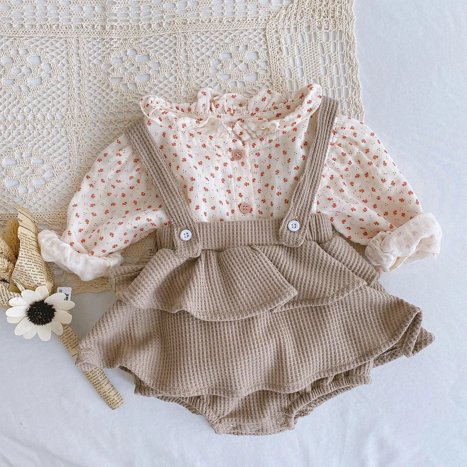 Baby girl romper with pleated lotus leaf design in cotton fabric, showing triangle climb style