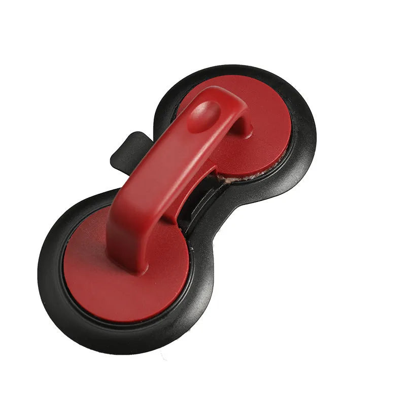Black or red food-grade ABS burger press mould with oil paper liners on a kitchen surface.