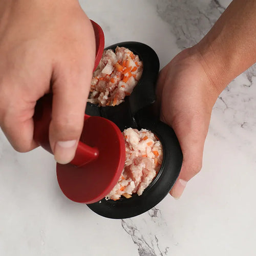 Black or red food-grade ABS burger press mould with oil paper liners on a kitchen surface.