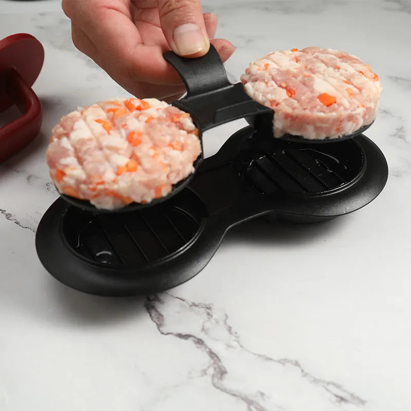 Black or red food-grade ABS burger press mould with oil paper liners on a kitchen surface.
