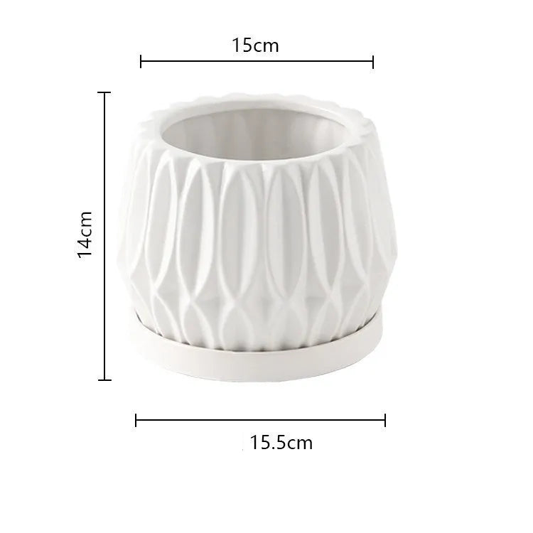 A simple grey ceramic flowerpot on a tabletop, medium sized for plants.