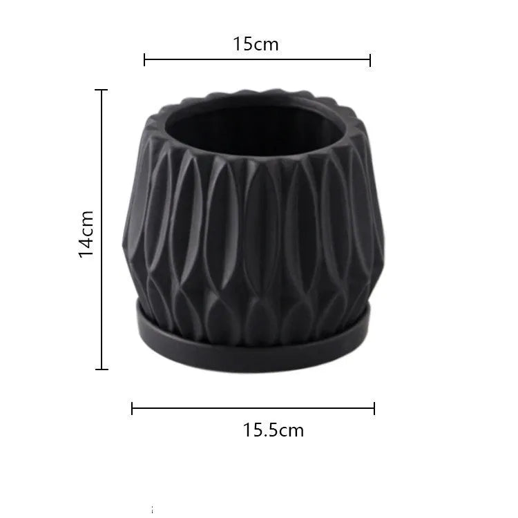 A simple grey ceramic flowerpot on a tabletop, medium sized for plants.