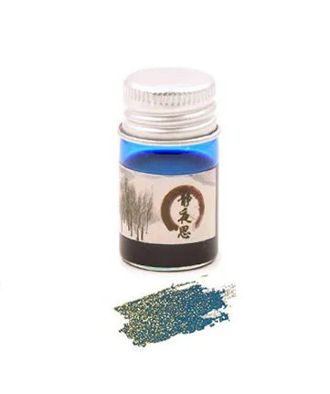Set of six small glass bottles of pastel antiquity ink with gold powder for dipping pens.
