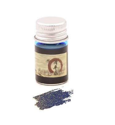 Set of six small glass bottles of pastel antiquity ink with gold powder for dipping pens.