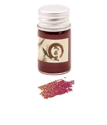 Set of six small glass bottles of pastel antiquity ink with gold powder for dipping pens.