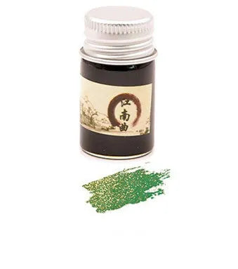 Set of six small glass bottles of pastel antiquity ink with gold powder for dipping pens.