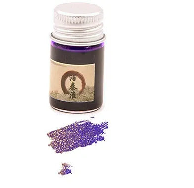 Set of six small glass bottles of pastel antiquity ink with gold powder for dipping pens.