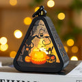 A portable Halloween decoration pumpkin lamp prop in plastic and glass, showing scale against a measuring tape.