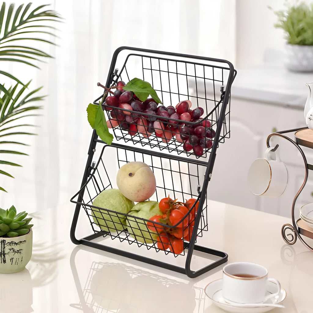 Two-tier black stainless steel kitchen storage rack with fruit and vegetables on a countertop