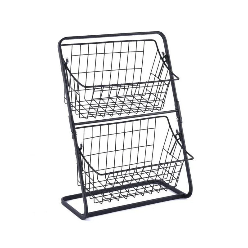 Two-tier black stainless steel kitchen storage rack with fruit and vegetables on a countertop