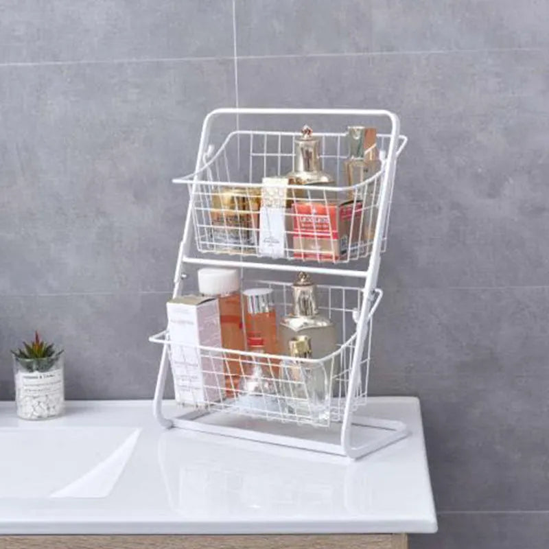 Two-tier black stainless steel kitchen storage rack with fruit and vegetables on a countertop