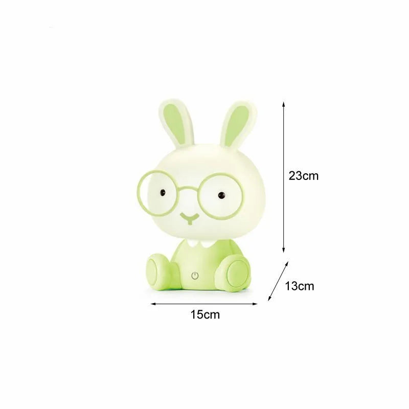 Blue cartoon rabbit-shaped USB night light with glasses on a table