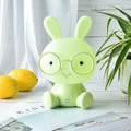 Blue cartoon rabbit-shaped USB night light with glasses on a table