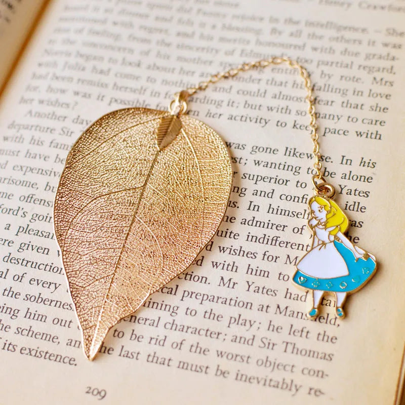 Metal leaf-shaped bookmark with a choice of Alice, rabbit, or clock charm designs on kraft card.