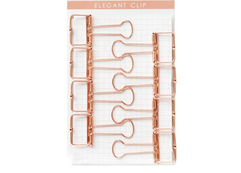 Rose gold metal ring binder set with small and large folders for documents on a desk