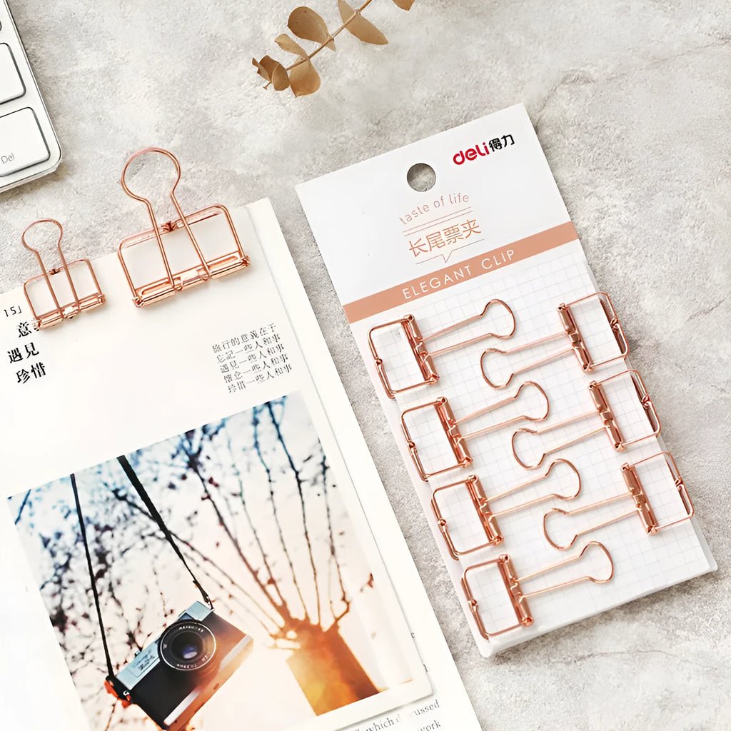 Rose gold metal ring binder set with small and large folders for documents on a desk