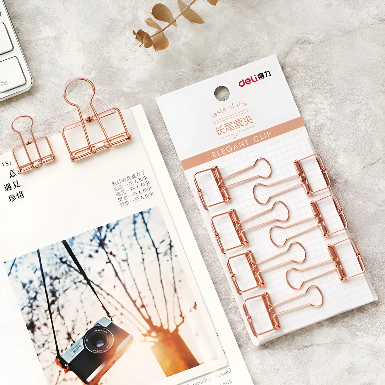 Rose gold metal ring binder set with small and large folders for documents on a desk