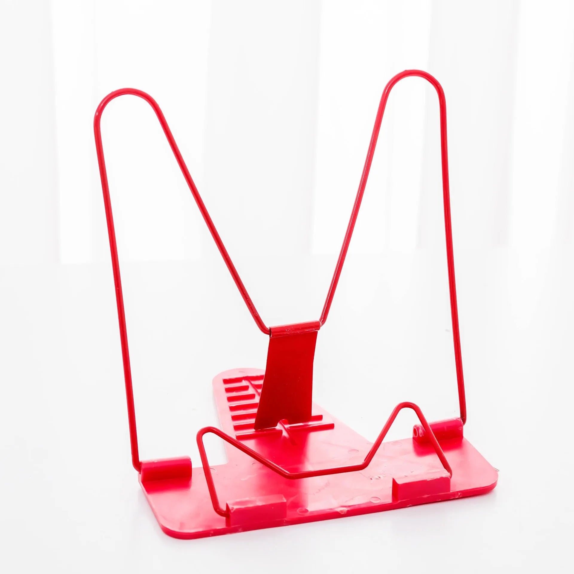 Adjustable metal and plastic reading frame in blue colour, holding book upright
