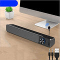 G18 small desktop speaker in black with Bluetooth, placed beside a computer monitor