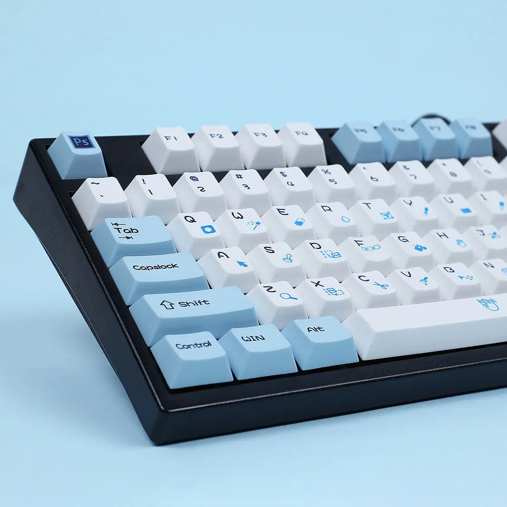 PlayStation-themed mechanical keyboard keycaps in blue and white or gray and white colour schemes
