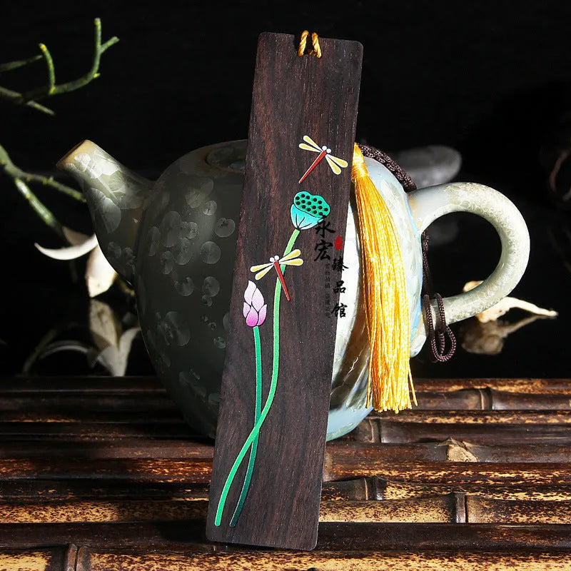 Chinese style painted lotus bookmark made from sandalwood with landscape flower decoration.