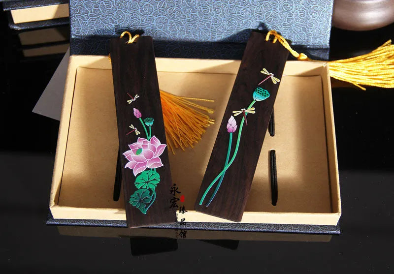 Chinese style painted lotus bookmark made from sandalwood with landscape flower decoration.